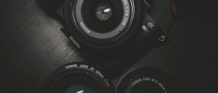 A camera on a dark surface, suggesting studio batch work