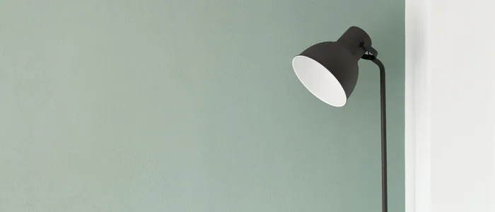 A bright lamp against a dark wall, suggesting light and dark themes